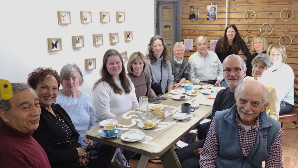 French speakers gathered around a table inside Bean Cycle Roasters of Fort Collins