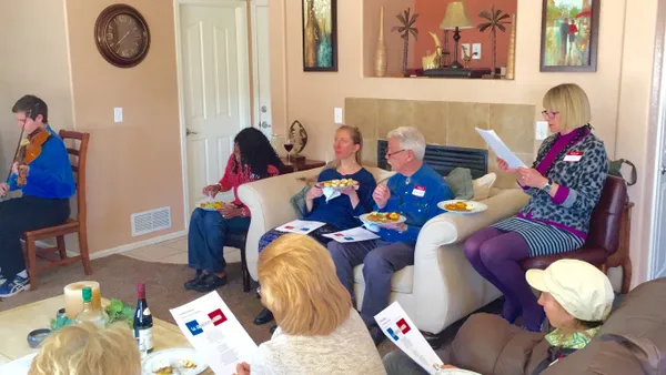 French speakers reading inside a living room